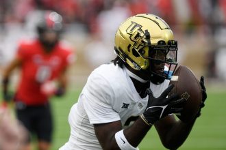 UCF's wide receiver Kobe Hudson (2) catches the ball against Texas Tech in a Big 12 football game, Saturday, Nov. 18, 2023, at Jones AT&T Stadium.