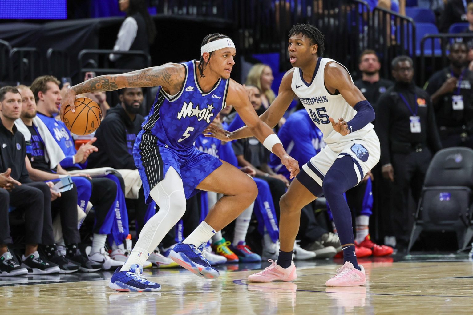 Mar 30, 2024; Orlando, Florida, USA; Orlando Magic forward Paolo Banchero (5) controls the ball in front of Memphis Grizzlies forward GG Jackson (45) during the second half at KIA Center. Mandatory Credit: Mike Watters-USA TODAY Sports